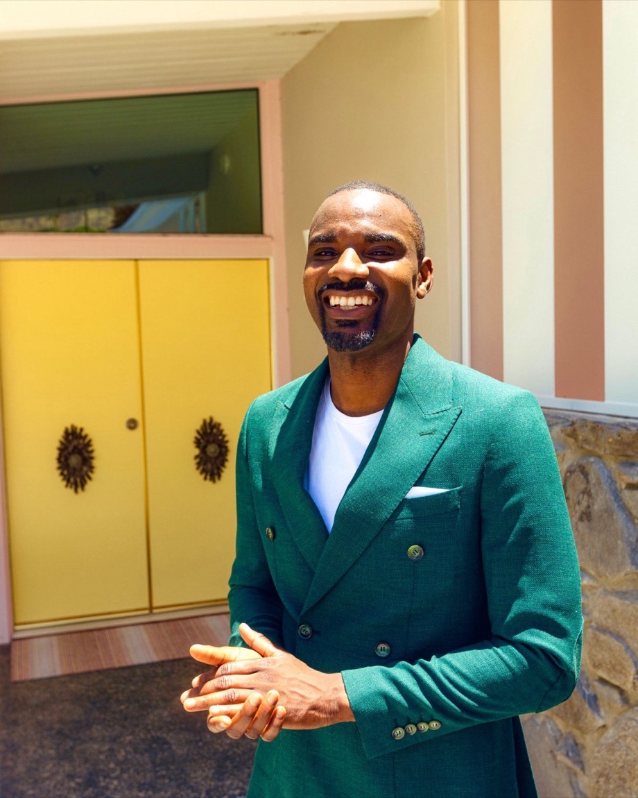 Preston Pollard in a green double-breasted suit, smiling