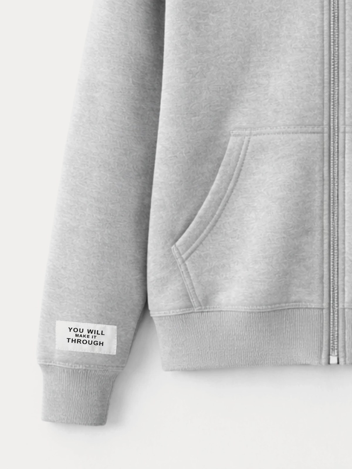 Close on the left sleeve: a woven white label reading YOU WILL MAKE IT THROUGH